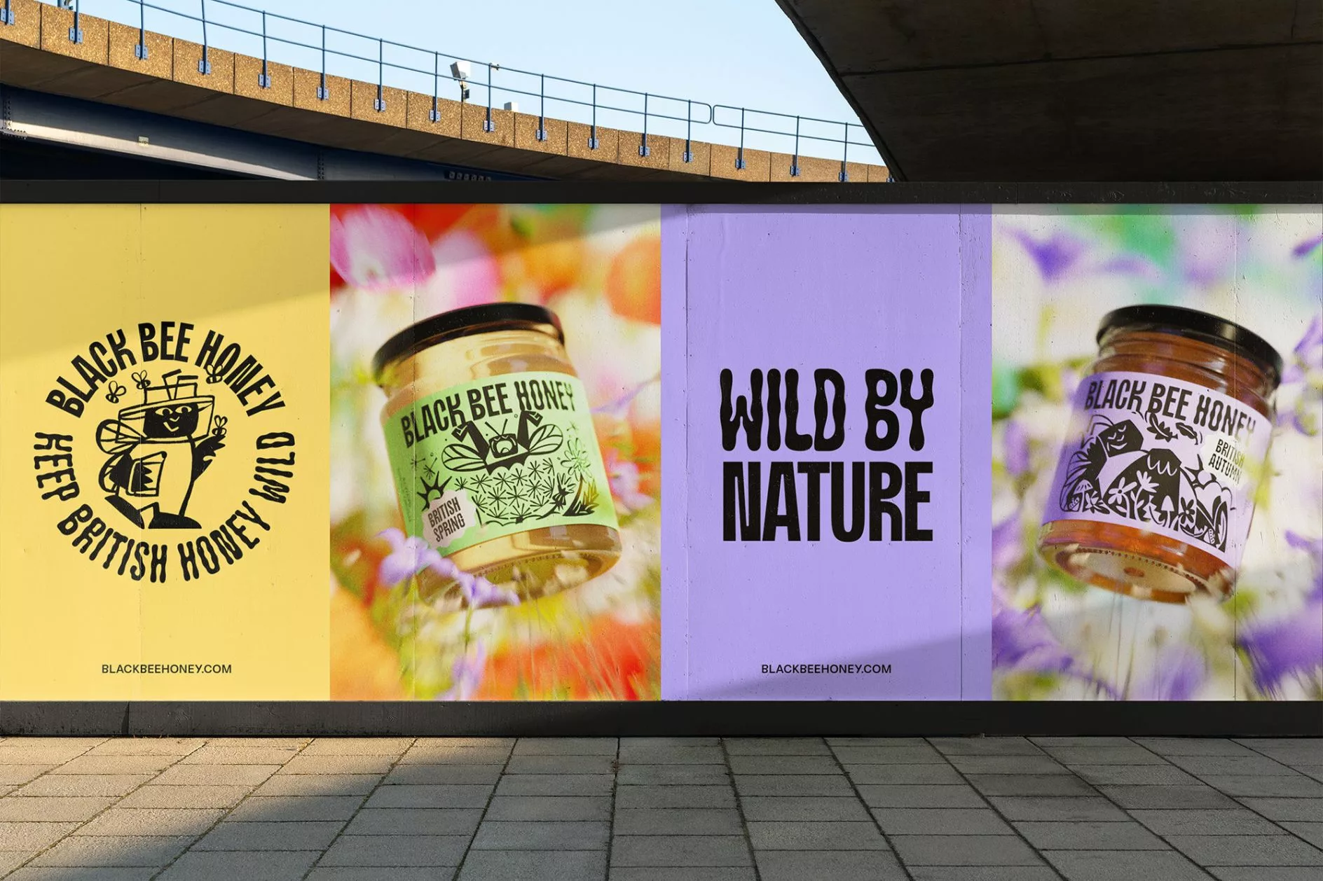 Billboard with "Black Bee Honey" branding. Features a smiling bee holding honey, vibrant jars labeled for spring and autumn, and "Wild by Nature" text. Bright, natural tones.