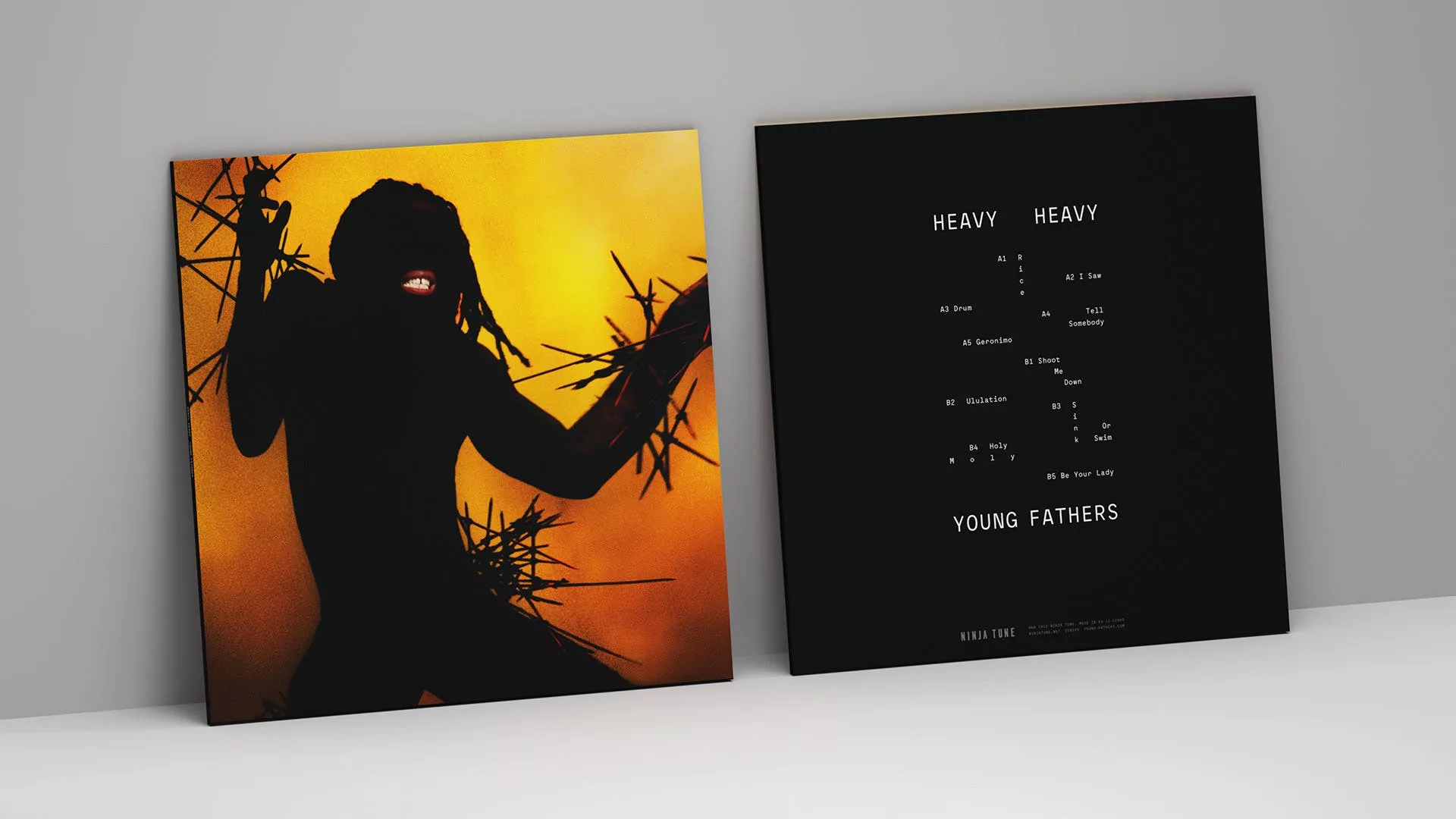 Album cover featuring a silhouetted figure with outstretched arms against an orange backdrop and thorn-like patterns. The tracklist sits on a black background.