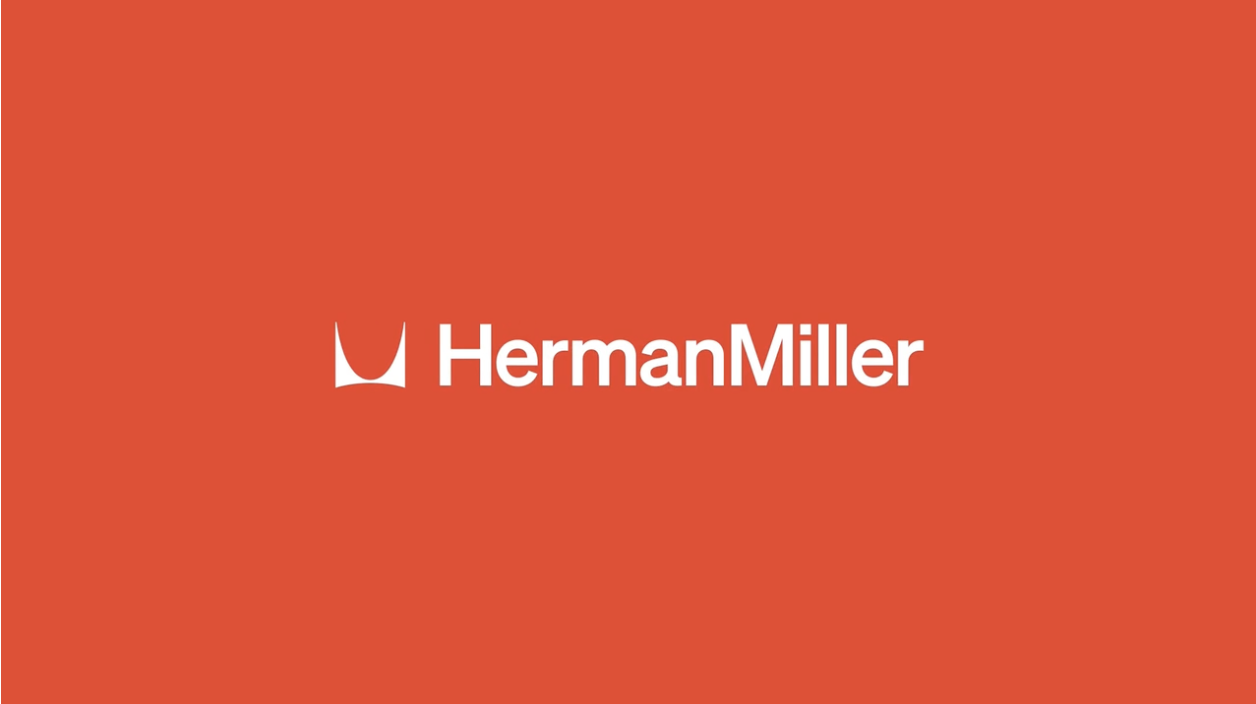 Red background with the white Herman Miller logo, featuring a stylised "M" and the company's name in bold, conveying modernity and elegance.